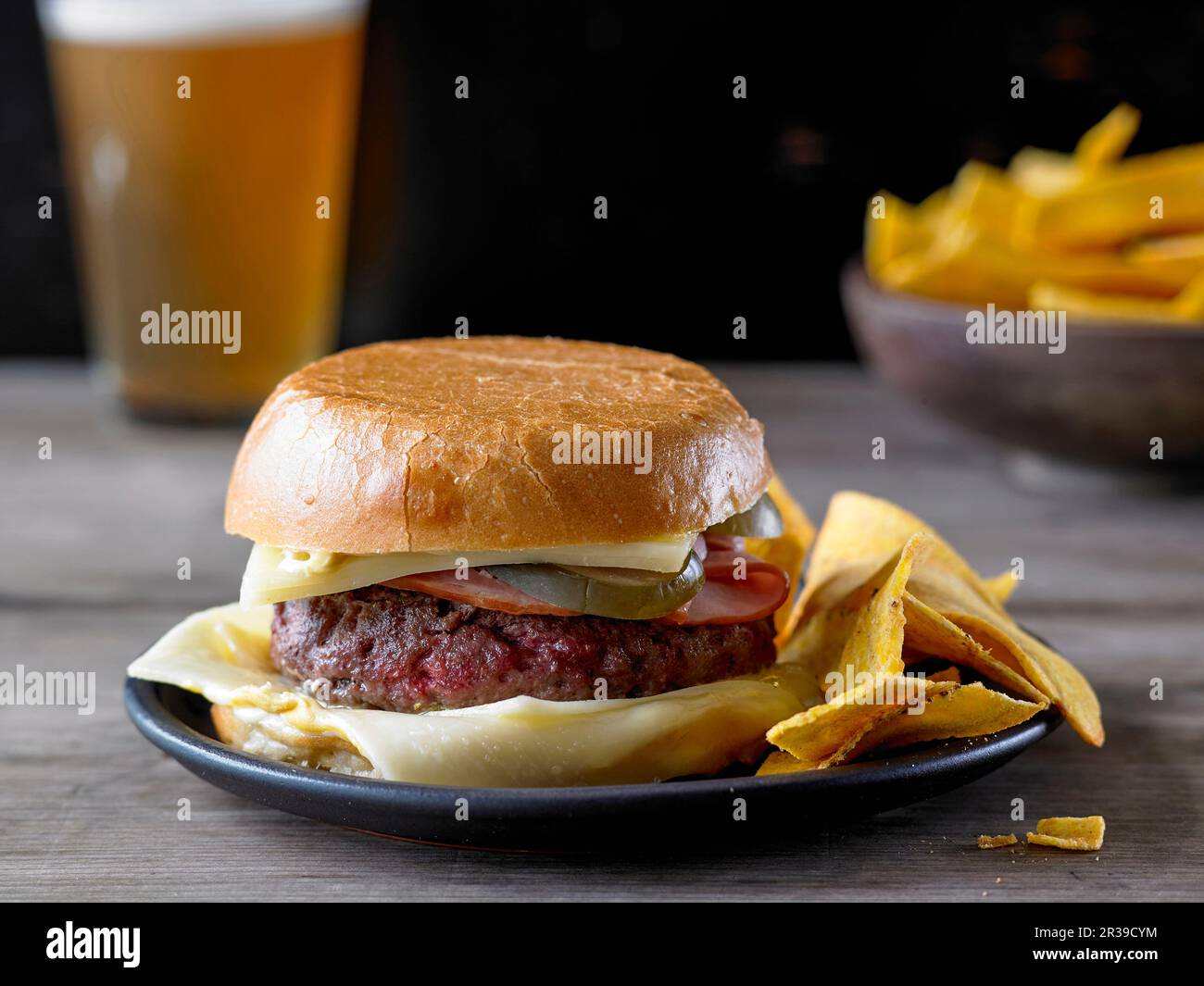 The Bobby Flay Ground Chuck Burger with Ham and Cheese and a side of