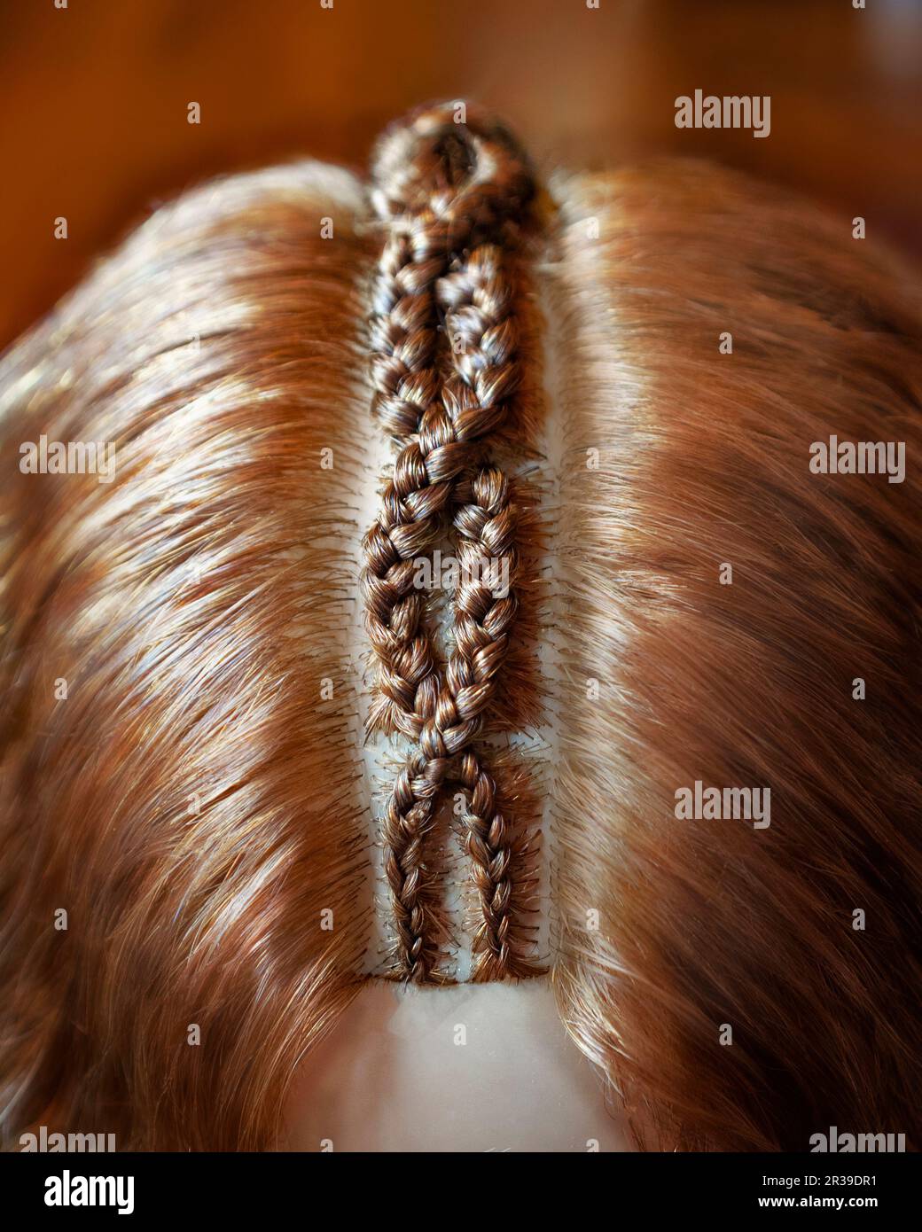 Drawings made of hair, braids texture, close-up background of hair Stock Photo