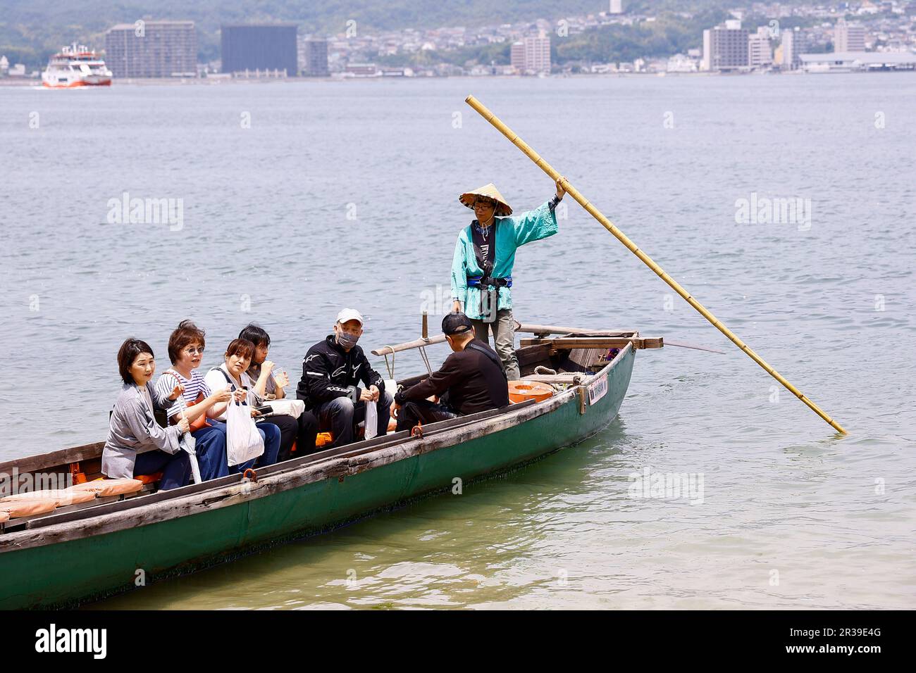 Miyajima, Japan, May 22, 2023 - Visitors enjoy a bout tour in Miyajima. Visitors returned to Itsukushima-jinja Shrine a day after the leaders’ meeting G7 Hiroshima Summit ended on May 21. The Shinto shrine is well known for its iconic floating Itsukushima Jinja Otorii (Grand Torii Gate) and World Heritage Site. Stock Photo