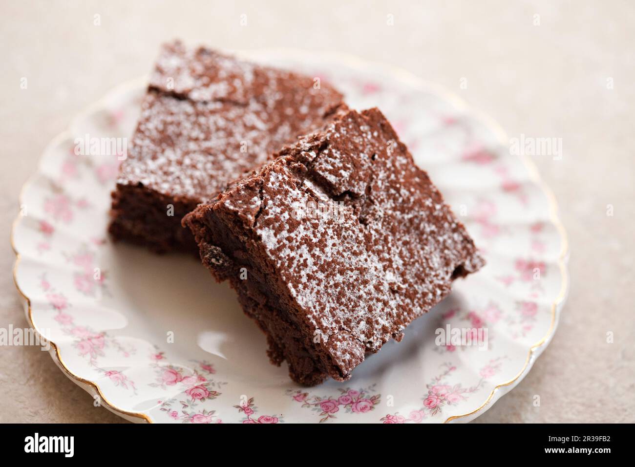 Chocolate brownie dusted with icing sugar Stock Photo Alamy