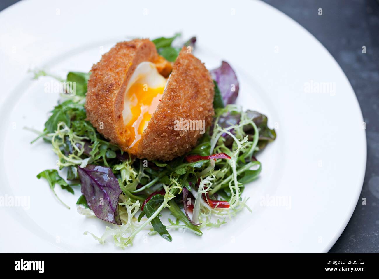 Scotch egg with golden runny yolk Stock Photo - Alamy