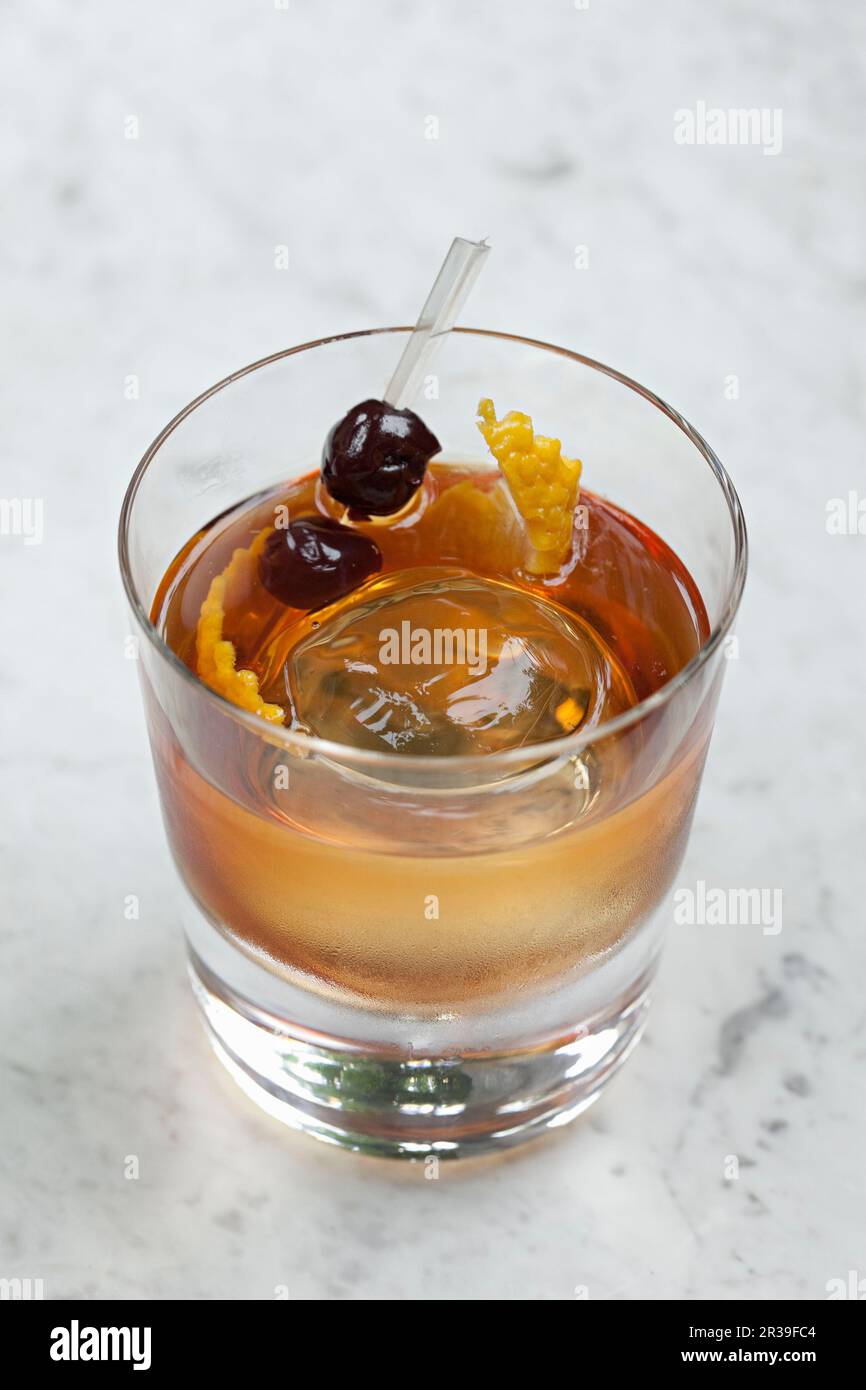Whiskey based cocktail with a ball of Ice Stock Photo Alamy