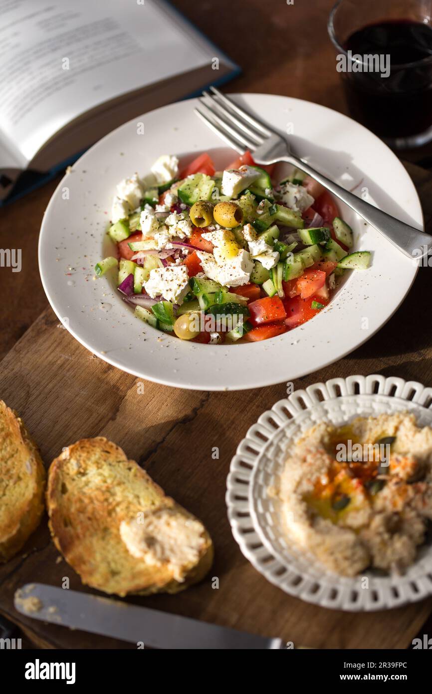 Greek salad with hummus and toasted bread Stock Photo Alamy