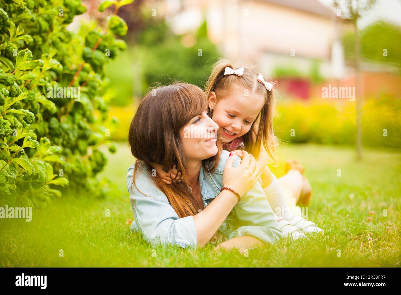 Young mother and daughter having fun together outdoors Stock Photo