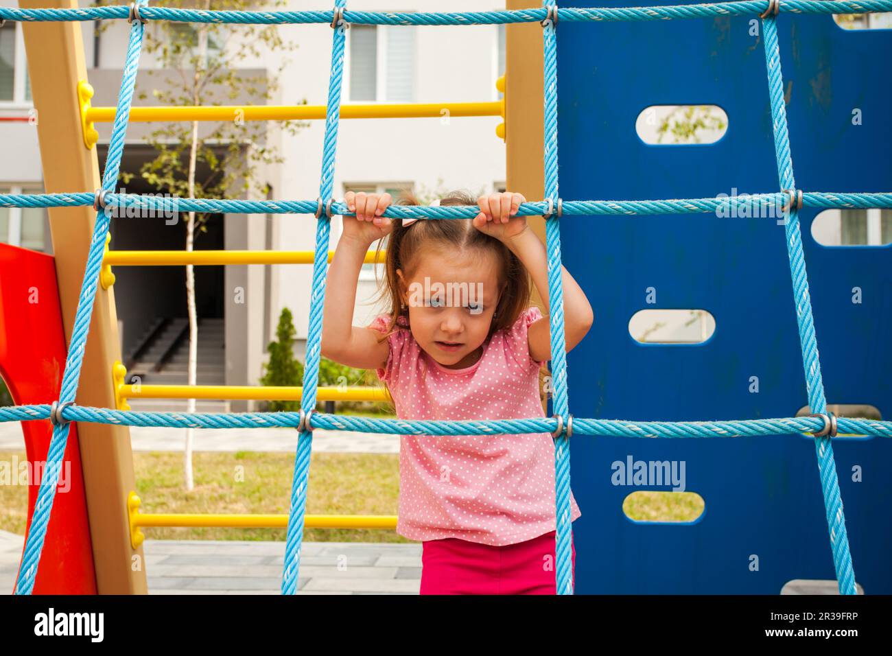 Adorable child girl playing on outdoors playground. Stock Photo