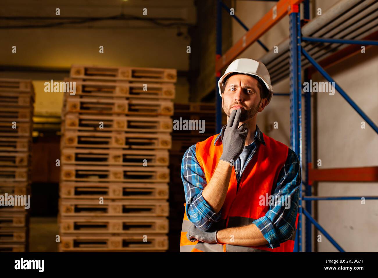 Thoughtful worker in protective uniform in the warehouse Stock Photo