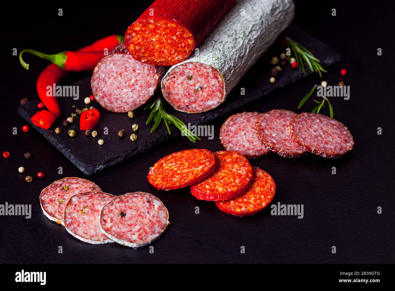 Different types of salami folded up with spices Stock Photo Alamy