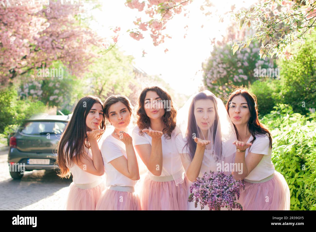 Happy girls making air kiss and looking to camera Stock Photo