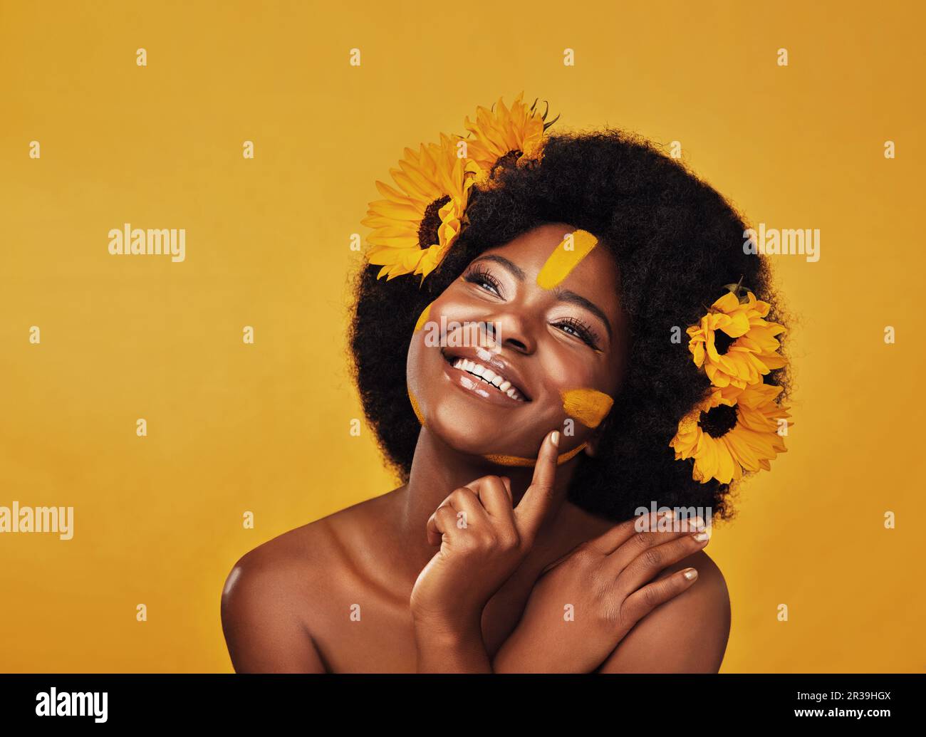Thinking, beauty and happy black woman with sunflower in studio for ...