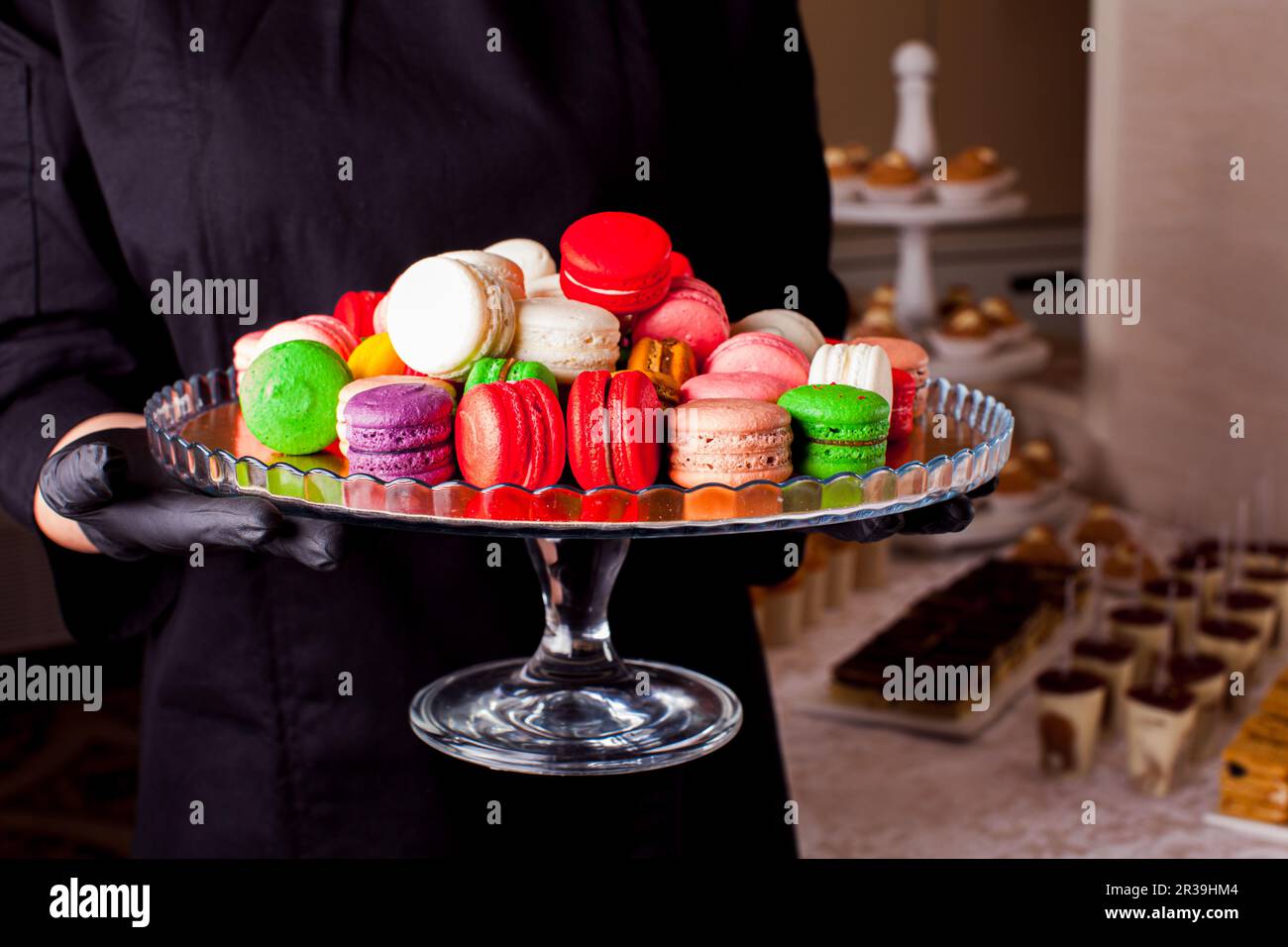 Colorful macaroons and other desserts served on the table Stock Photo