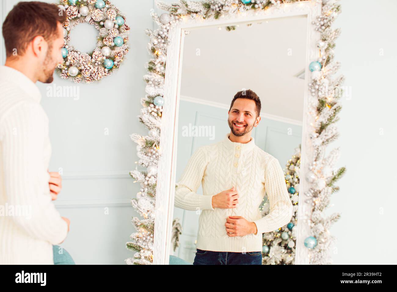 Portrait of young man near large mirror Stock Photo