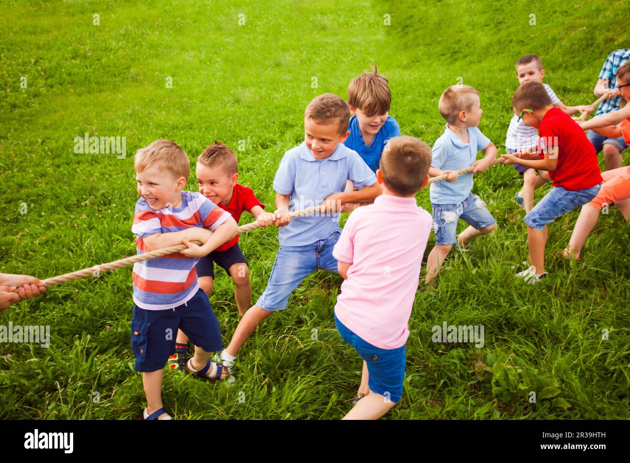 The team of boys in a game of tug of war Stock Photo Alamy