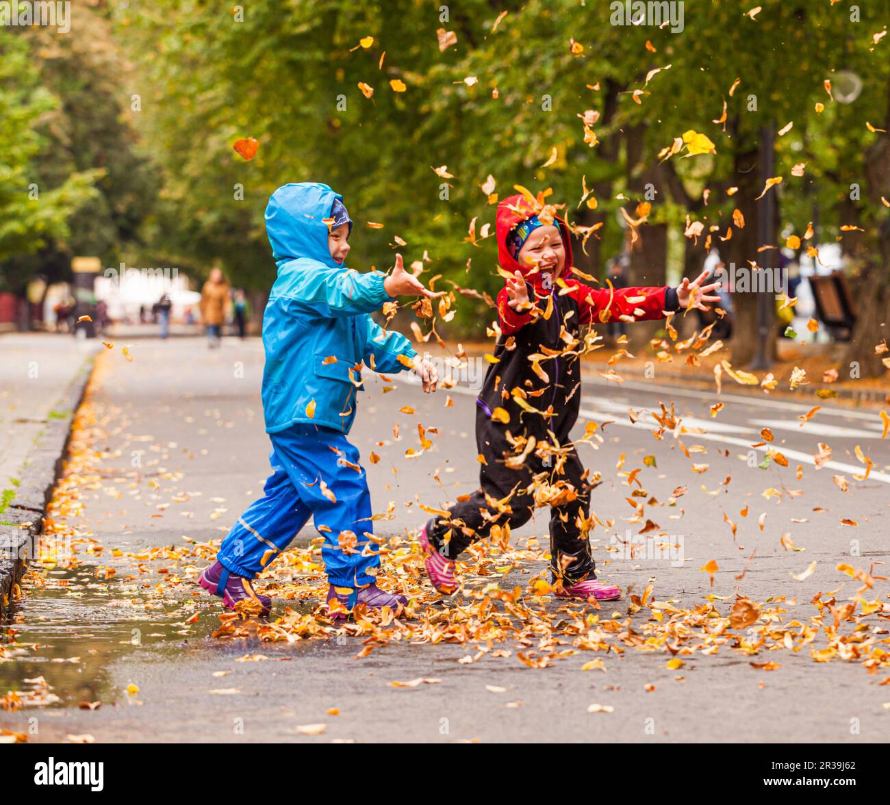 Kids playing in rain hi-res stock photography and images - Alamy, playing 