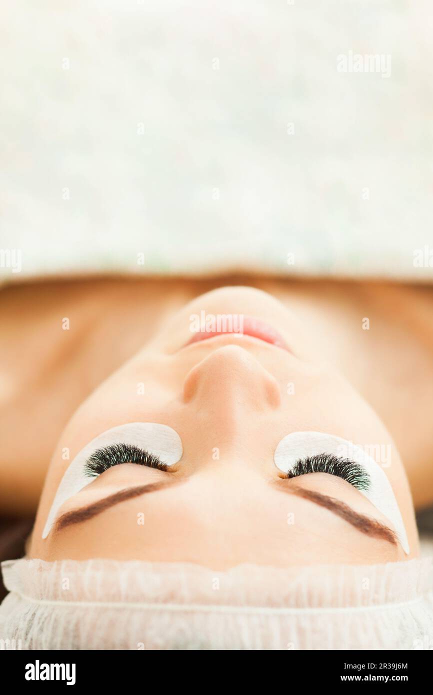 Eyelash extension procedure close up. Beauty concept Stock Photo