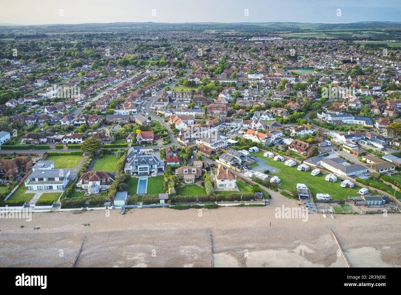 Aerial view over the West Sussex village of East Preston on the Southern Coast of England from the beach towards sea lane. Stock Photo