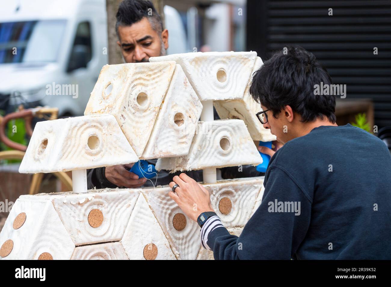 London, UK.  23 Mary 2023. Staff members assemble 'Symbiocene Living' by PLP Architecture, made from mycelium, in Clerkenwell as part of Clerkenwell Design Week which runs to 25 May.    Credit: Stephen Chung / Alamy Live News Stock Photo