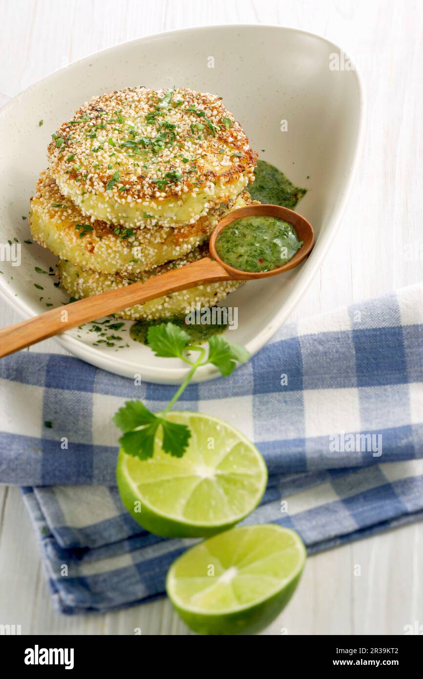 Fried potato cakes with amaranth pops and lime and herb sauce Stock Photo