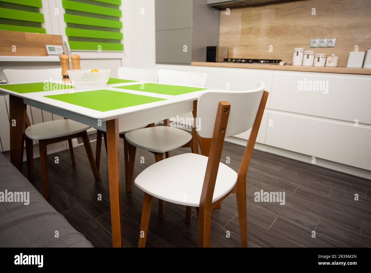 Modern white contemporary kitchen interior. Stylish dining table and chairs. Stock Photo