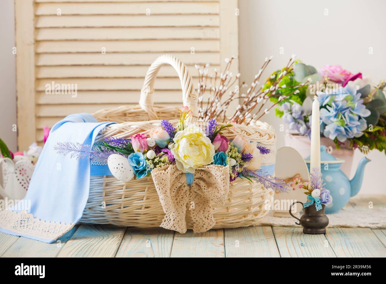Multicolored Easter wicker basket on a wood background Stock Photo