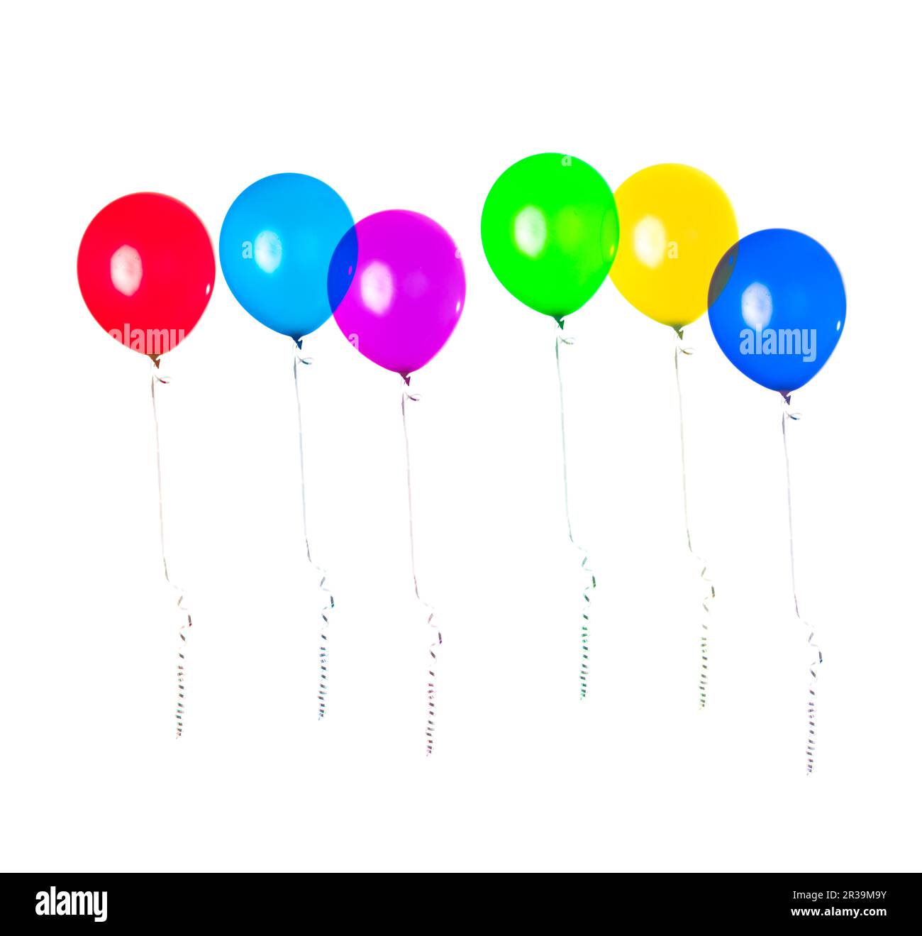 Row of party balloons hanging in the air on white background. Birthday decoration. Stock Photo