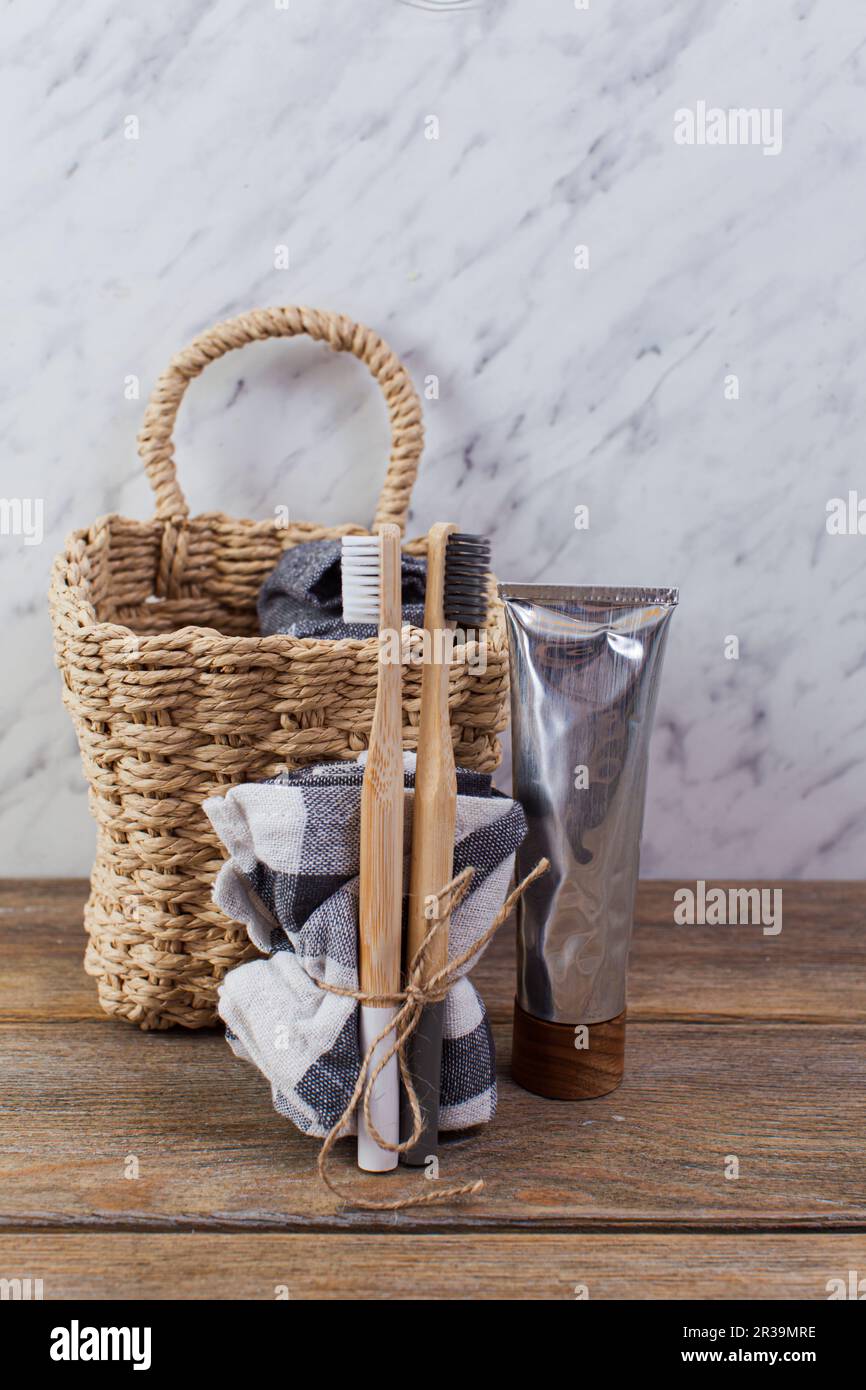 Bamboo toothbrushes and paste on light table Stock Photo