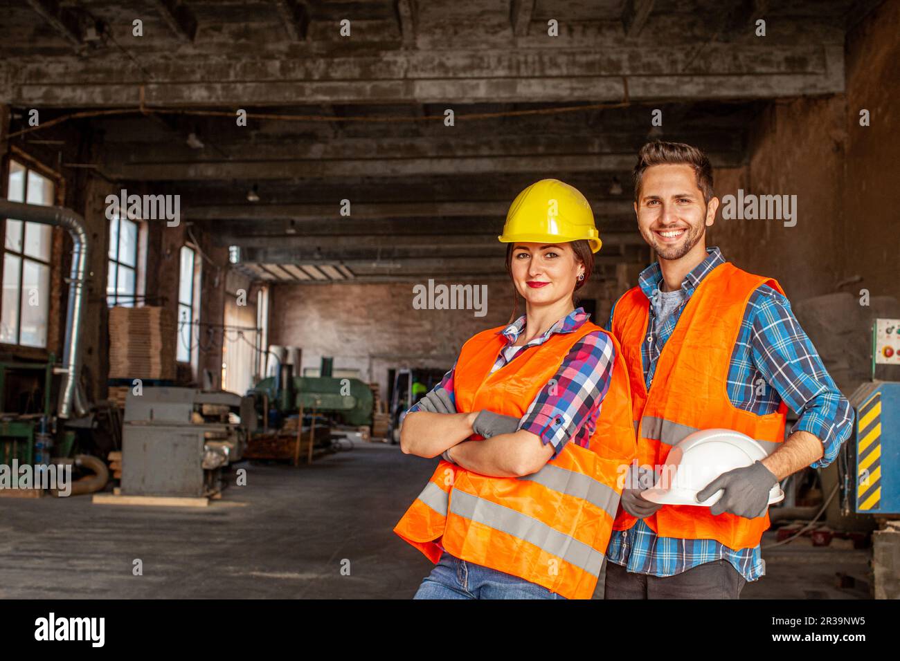 Pair of attractive workers indoors woodworking workflore Stock Photo