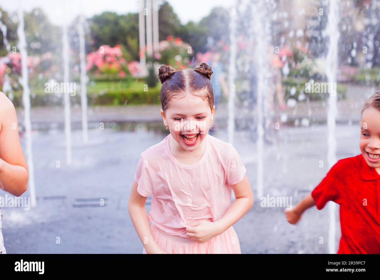 Loud kids laughter in a city fountain Stock Photo