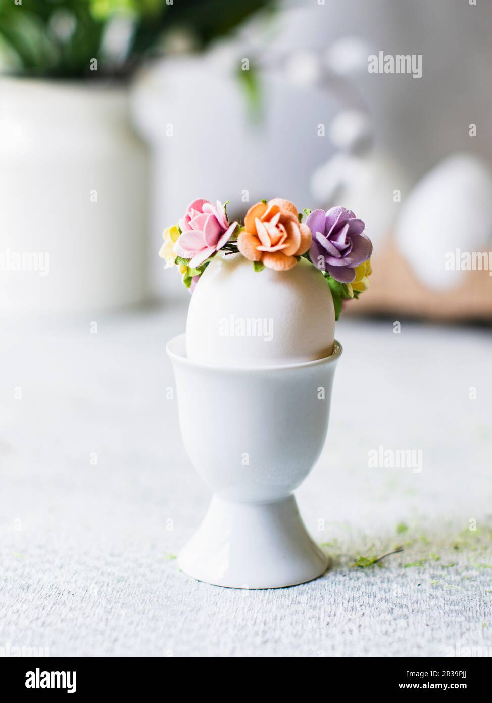 Easter egg with flower decoration in an eggcup Stock Photo