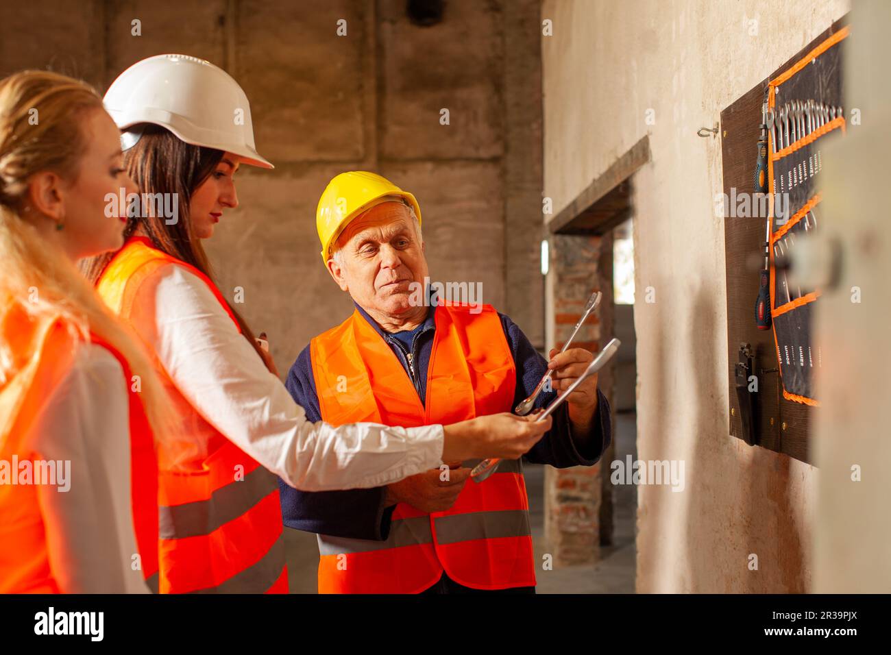 Experienced mechanic showing his tools to newcomers Stock Photo