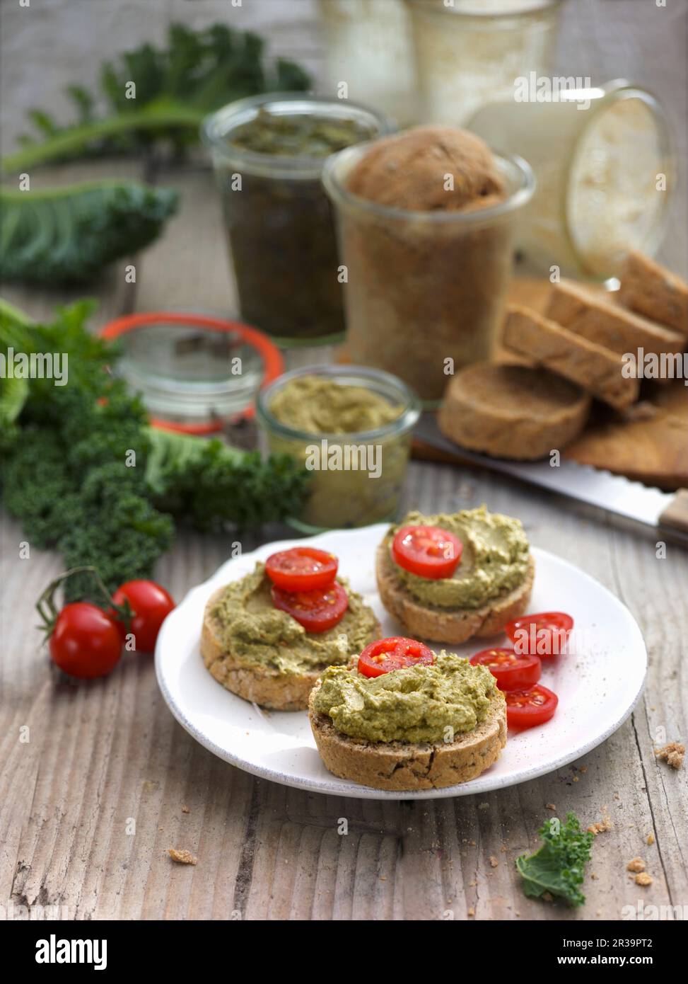 Kale cream and cherry tomatoes on country bread Stock Photo