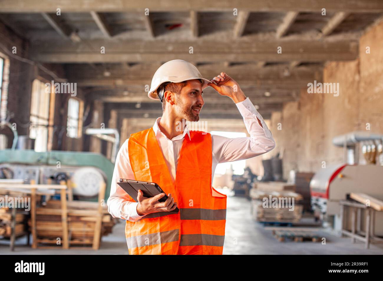 Young factory worker with tablet in his hand Stock Photo