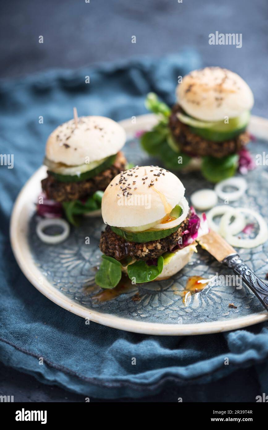 Vegan mini burgers with beluga lentil fritters, lamb's lettuce
