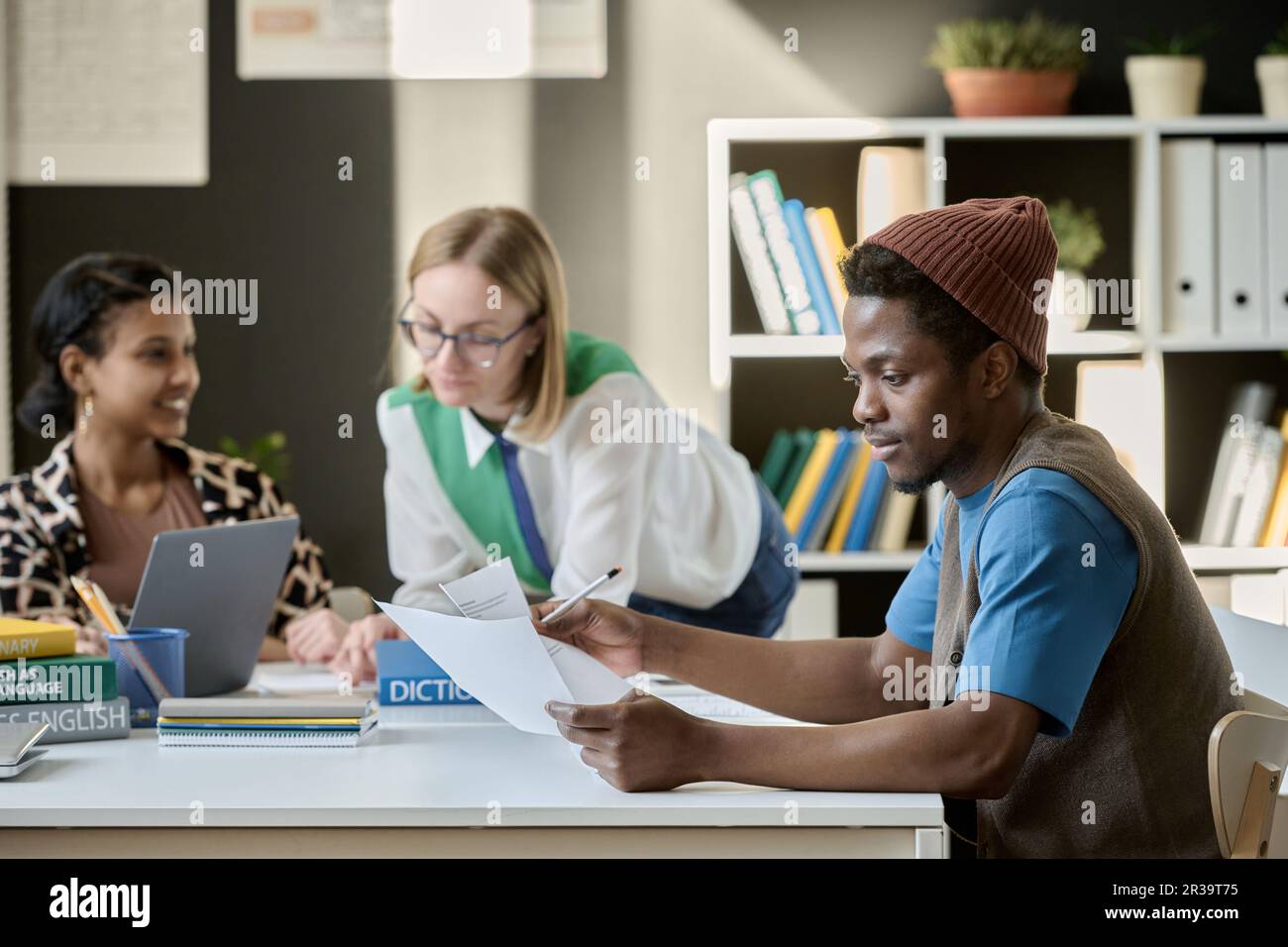 African American student studying English in English school together with other students Stock Photo
