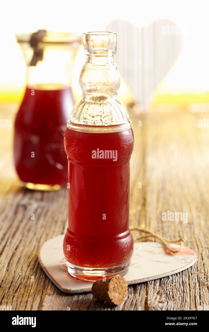 Homemade apple liqueur with lemon, grenadine and corn alcohol Stock