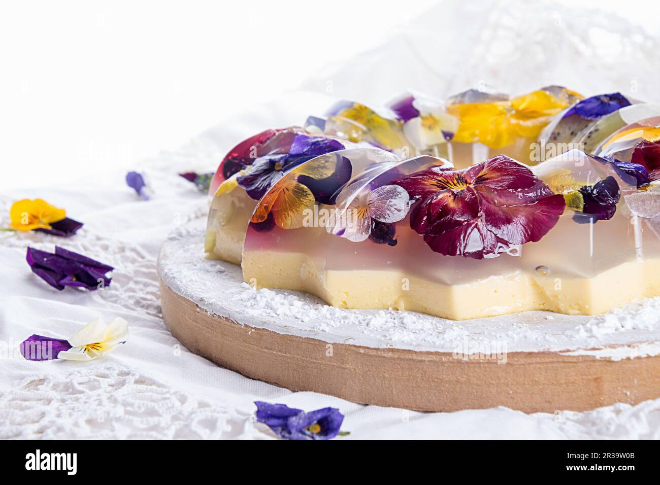 Unique japanese dessert Havaro of jelly and bavarian cream with edible violet flowers Stock Photo