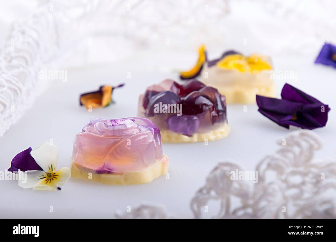 Unique japanese dessert Havaro of jelly and bavarian cream with edible violet flowers Stock Photo