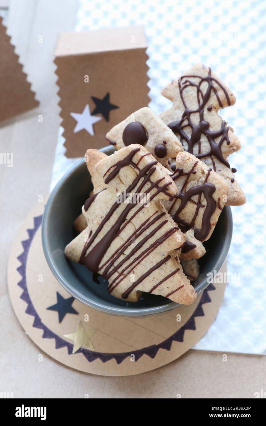 Gluten-free shortbread biscuits shaped like Christmas trees with chocolate icing Stock Photo