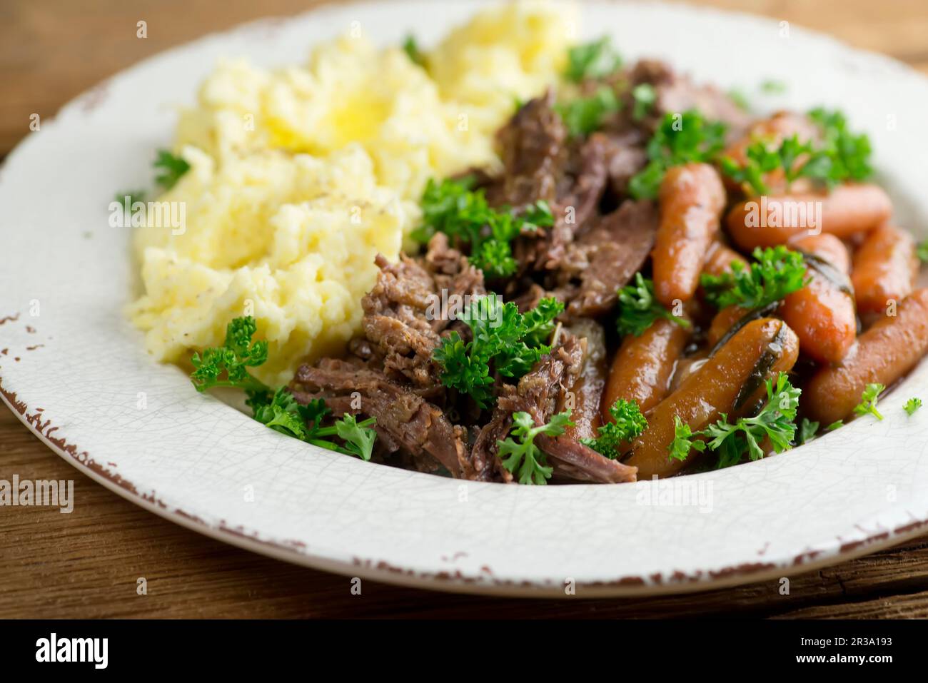 Pot roast with baby carrots and mashed potatoes Stock Photo