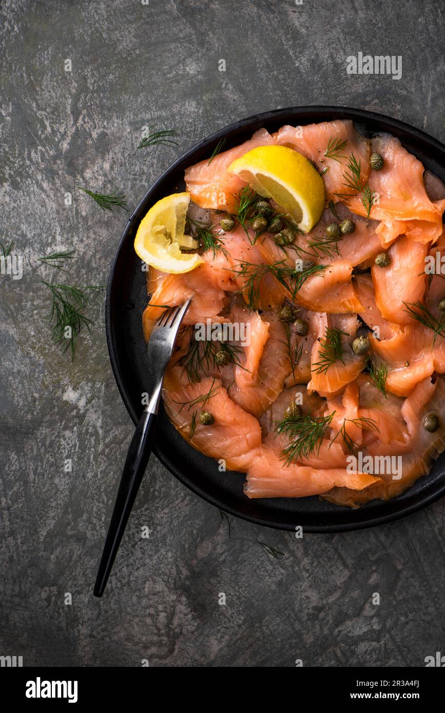 Smoked salmon with capers, lemon and fresh dill Stock Photo Alamy