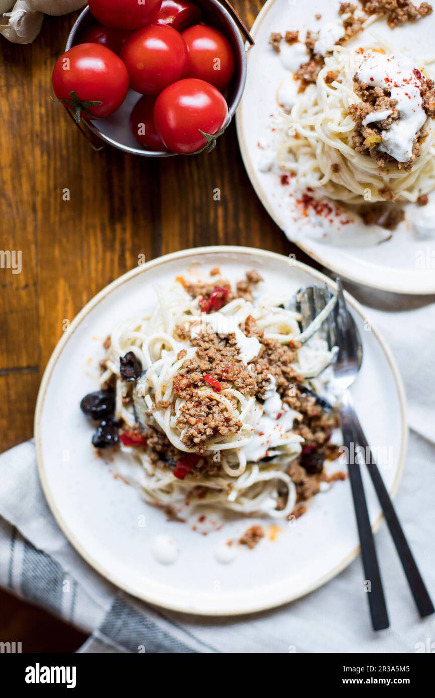 Spaghetti with minced meat, aubergines and yoghurt Stock Photo Alamy