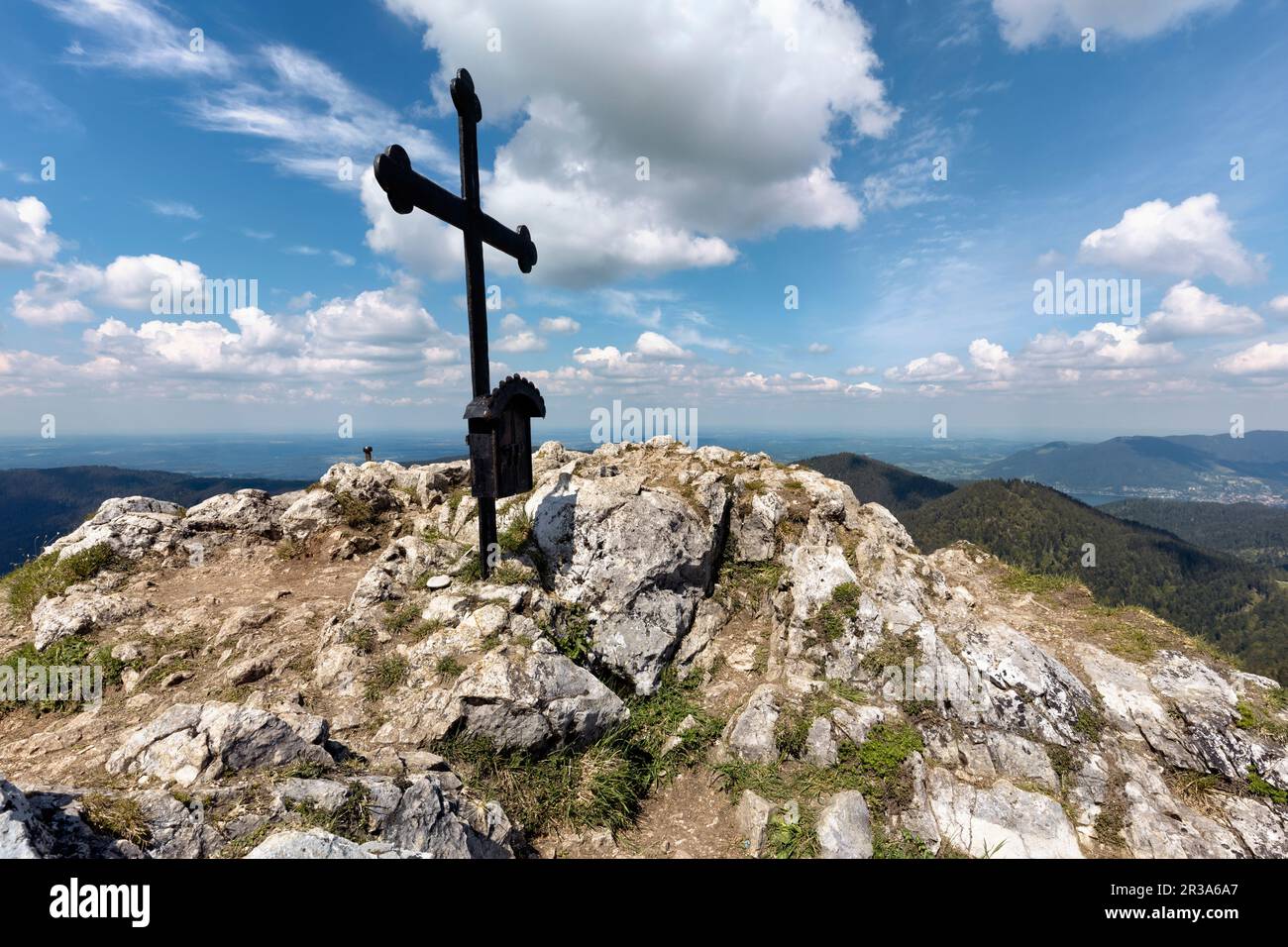 Summit cross on the Fockenstein peak in Bavaria, Germany, in springtime Stock Photo