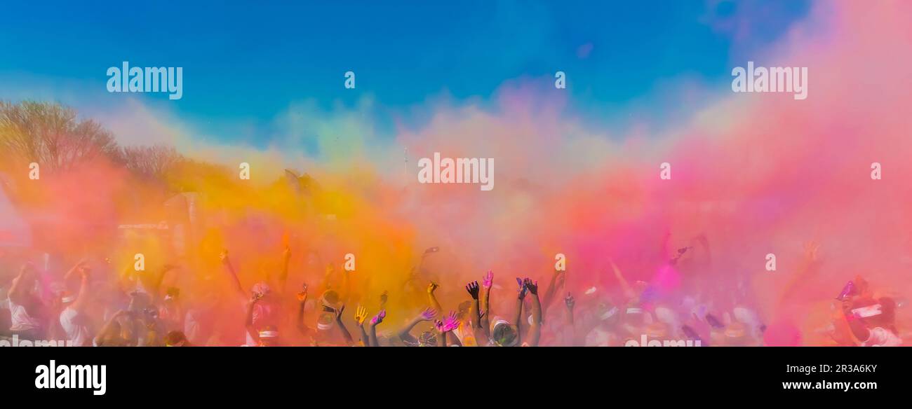 Crowd throwing bright colored powder paint in the air, The Color Run