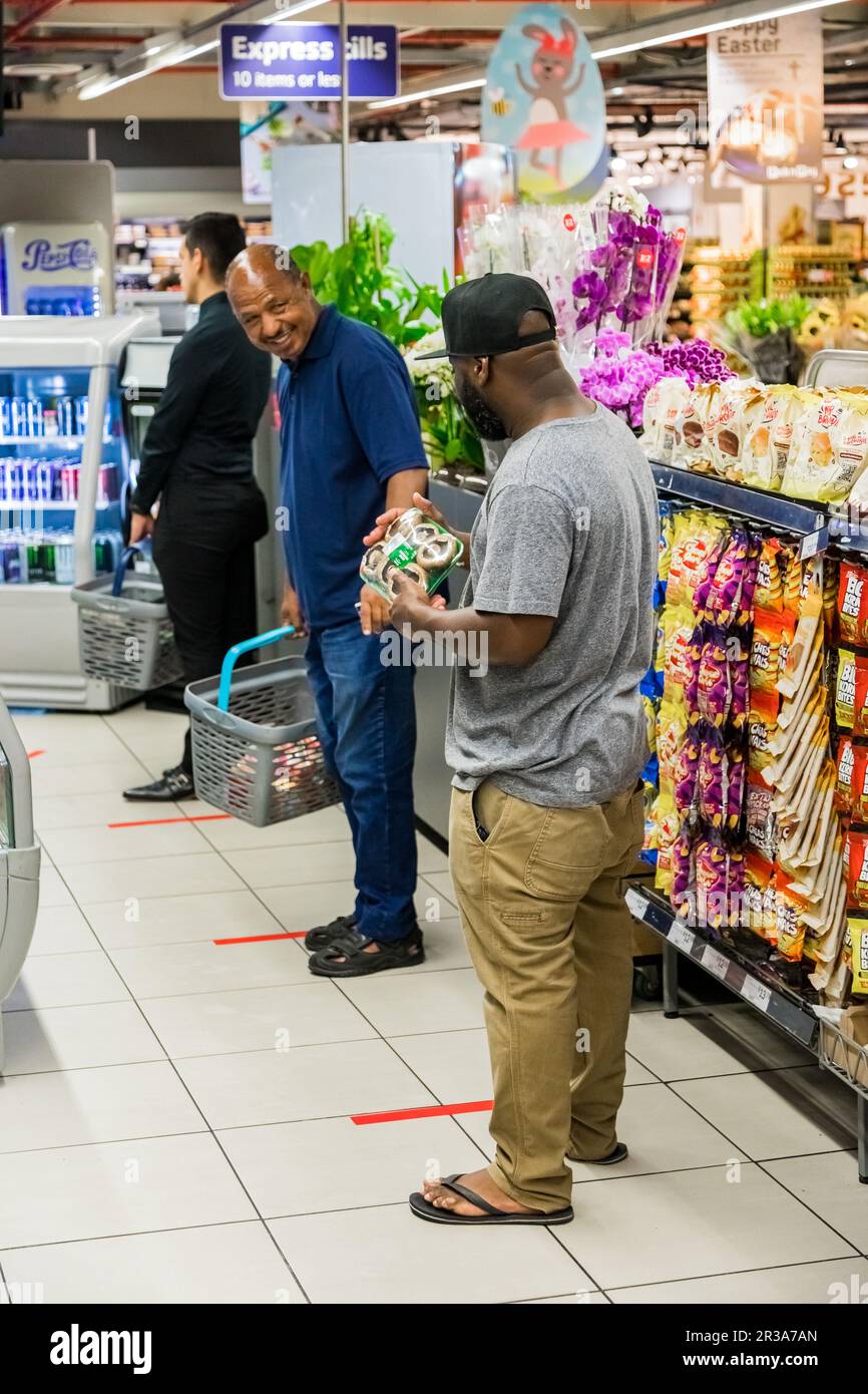 Retail shoppers practicing social distancing at Pick 'n Pay grocery store during virus outbreak