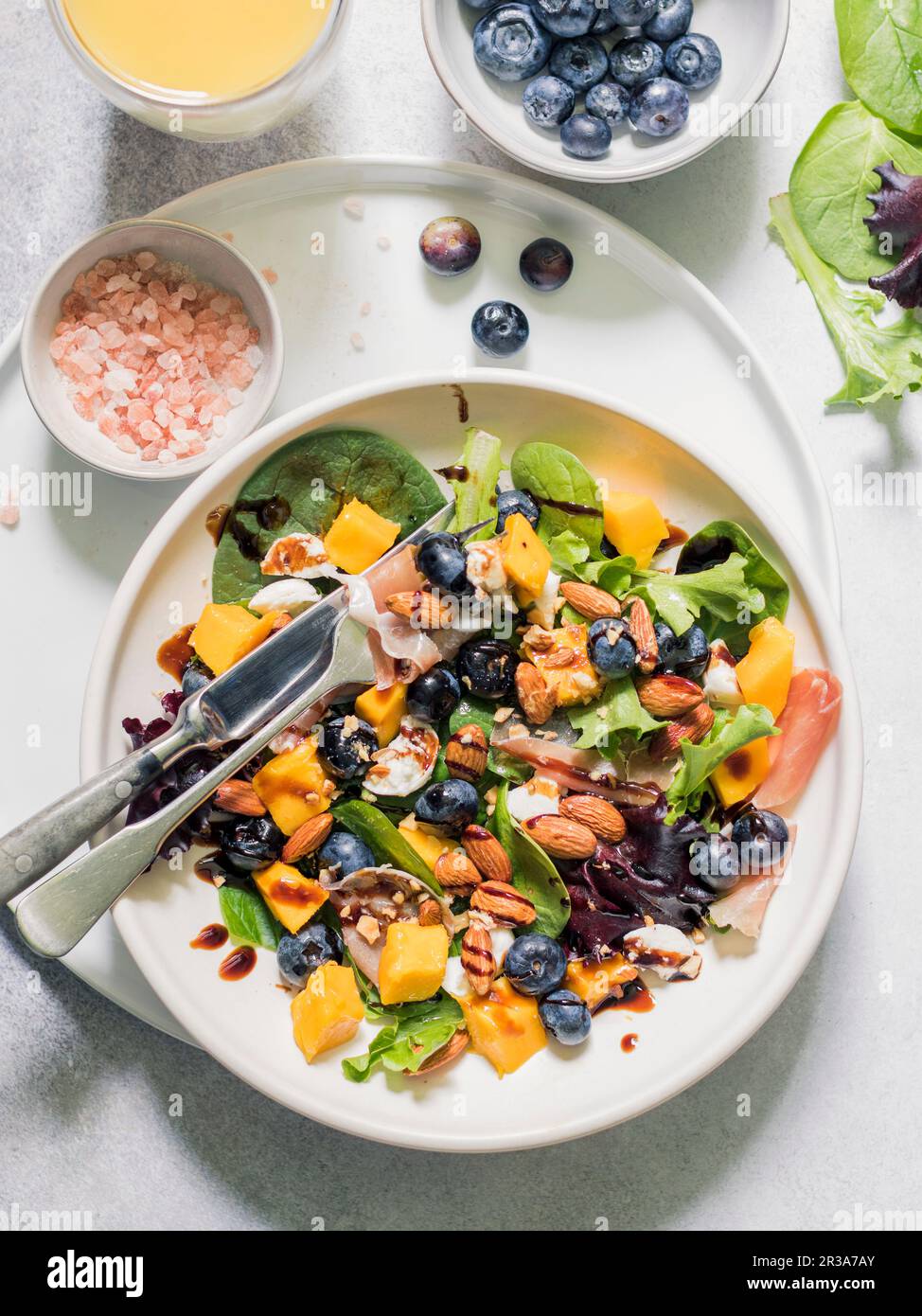 Spring mix salad with mango, blueberries and prosciutto Stock Photo Alamy
