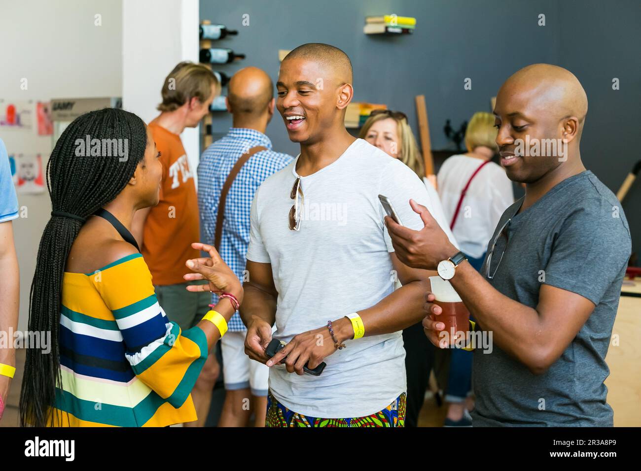 African Friends eating, drinking and generally enjoying a day out at a Food and Wine Fair Stock