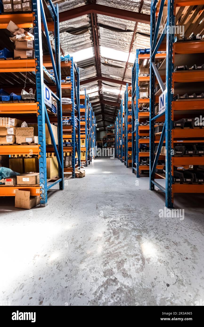 Interior of empty industrial parts distribution warehouse shelves Stock