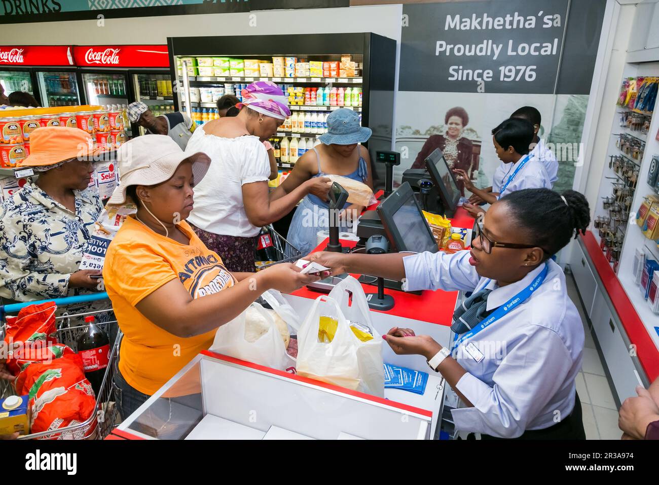 African cashier and customer at checkout at local Pick n Pay grocery