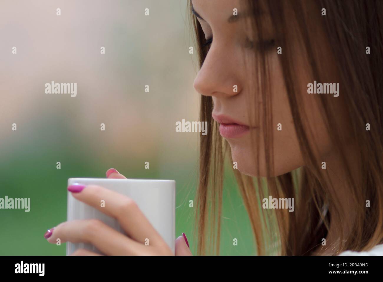 mujer joven bebiendo de una taza,islas baleares, Spain. Stock Photo