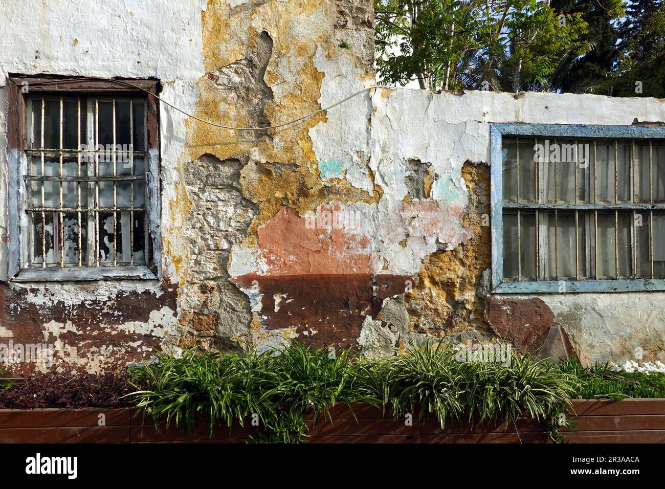 Facade of an old abandoned uninhabited house with destroyed plaster and ...