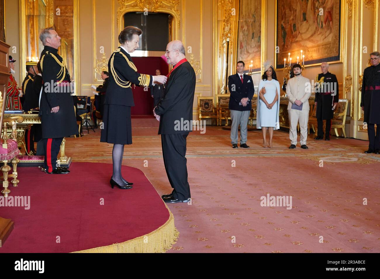 Sir Salman Rushdie is made a Companion of Honour by the Princess Royal at Windsor Castle. The honour recognises services to literature. Picture date: Tuesday May 23, 2023. Stock Photo